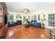 Open living room area features hardwood floors, a fireplace, large windows, and access to the dining room and a view to the backyard at 530 Shady Oaks Dr, Stanley, NC 28164