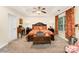 Main bedroom boasting tray ceilings, a ceiling fan, and decorative window treatments at 530 Shady Oaks Dr, Stanley, NC 28164