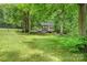 Charming shed nestled in a serene backyard with mature trees, providing extra storage and character at 530 Shady Oaks Dr, Stanley, NC 28164