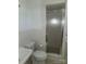 Bathroom features tiled walls and floors, toilet, sink, and shower with glass door at 536 Catalina Dr, Albemarle, NC 28001