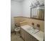 Bathroom features tiled walls and floors, toilet, sink, and a mirrored medicine cabinet at 536 Catalina Dr, Albemarle, NC 28001