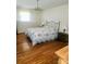 Bright bedroom with hardwood floors, floral bedding, and a traditional chandelier at 536 Catalina Dr, Albemarle, NC 28001