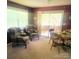 Cozy breakfast nook filled with natural light, traditional furniture and a view of screened porch at 536 Catalina Dr, Albemarle, NC 28001