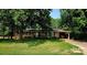 Charming brick ranch home featuring a covered carport, manicured lawn, and mature trees at 536 Catalina Dr, Albemarle, NC 28001