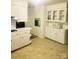 Bright kitchen with white cabinets, brick accents and vintage appliances at 536 Catalina Dr, Albemarle, NC 28001