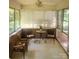 Relaxing screened porch with brick accents, casual seating and natural light at 536 Catalina Dr, Albemarle, NC 28001
