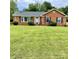 Charming brick home with a lush green lawn and well-maintained landscaping at 5734 Brookhaven Rd, Charlotte, NC 28210