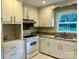 Well-maintained kitchen featuring white cabinetry, granite countertops, and functional appliances at 5734 Brookhaven Rd, Charlotte, NC 28210
