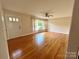 Bright living room featuring hardwood floors, neutral walls, and a ceiling fan at 5734 Brookhaven Rd, Charlotte, NC 28210