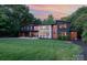 Striking modern home with unique architectural details and a well-manicured front lawn at sunset at 5925 Creola Rd, Charlotte, NC 28270