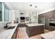 Modern kitchen with quartz countertops, island with seating, and stainless steel appliances overlooking the living area at 5925 Creola Rd, Charlotte, NC 28270