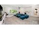 Spacious living room area with plush blue sectional sofa, mini kitchen, and ample natural light at 5925 Creola Rd, Charlotte, NC 28270
