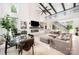 Open-concept living room with soaring ceilings, fireplace, large windows, and modern furnishings at 5925 Creola Rd, Charlotte, NC 28270
