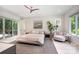 Bright main bedroom with hardwood floors, a sitting area, ensuite access, and plenty of natural light at 5925 Creola Rd, Charlotte, NC 28270