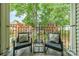 Balcony with comfortable seating and a table overlooking a landscaped yard at 5927 Quail Hollow Rd # H, Charlotte, NC 28210