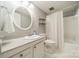 Bright bathroom featuring a tiled floor, round mirror, and a shower behind a curtain at 5927 Quail Hollow Rd # H, Charlotte, NC 28210