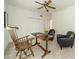 Bright, carpeted bedroom with a ceiling fan and a rustic table and chairs at 5927 Quail Hollow Rd # H, Charlotte, NC 28210