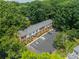 Aerial view of brick apartments with black shutters, surrounded by lush greenery and parking at 5927 Quail Hollow Rd # H, Charlotte, NC 28210