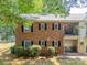 Exterior of two-story brick apartments featuring balconies, patios and manicured lawns at 5927 Quail Hollow Rd # H, Charlotte, NC 28210