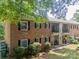 Exterior of two-story brick apartments featuring balconies, patios and manicured lawns at 5927 Quail Hollow Rd # H, Charlotte, NC 28210