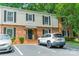 Exterior facade of a brick and vinyl clad townhouse featuring black shutters and assigned parking at 5927 Quail Hollow Rd # H, Charlotte, NC 28210