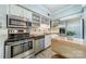Bright kitchen features stainless steel appliances, butcher block counters, and white cabinets at 5927 Quail Hollow Rd # H, Charlotte, NC 28210