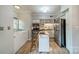 Bright kitchen features stainless steel appliances, butcher block counters, and center island with breakfast bar seating at 5927 Quail Hollow Rd # H, Charlotte, NC 28210