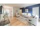 Bright living room with a striking blue accent wall, plush seating and light wood flooring at 5927 Quail Hollow Rd # H, Charlotte, NC 28210