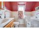 Bathroom with white tile, cherry-painted ceiling, Jacuzzi tub, and a window at 611 E Marion St, Shelby, NC 28150