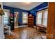 Blue bedroom featuring wood-look floors, two windows, and a bookcase at 611 E Marion St, Shelby, NC 28150