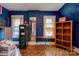 Bedroom featuring wood-look floors, two windows, and a bookcase at 611 E Marion St, Shelby, NC 28150