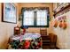 Inviting breakfast nook with floral accents, featuring a window with sheer curtains and a small wooden table at 611 E Marion St, Shelby, NC 28150