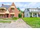 View of a charming brick Tudor-style home with arched entryway and adjacent property at 611 E Marion St, Shelby, NC 28150