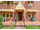 Close-up of a brick Tudor-style home's front door, showcasing architectural details at 611 E Marion St, Shelby, NC 28150