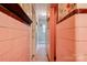 Hallway with pink tile and floral wallpaper leads to more of the home at 611 E Marion St, Shelby, NC 28150