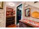 Hallway with wooden shelving and patterned wallpaper leading to the kitchen at 611 E Marion St, Shelby, NC 28150