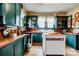 Cozy kitchen featuring wood countertops, green cabinetry and center island with ample sunlight at 611 E Marion St, Shelby, NC 28150
