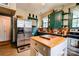 Traditional kitchen with stainless steel refrigerator and an island with butcher block countertop at 611 E Marion St, Shelby, NC 28150