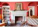 Living room featuring a fireplace with brick surround, built-in bookcases, and traditional decor at 611 E Marion St, Shelby, NC 28150