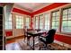 Bright home office with large windows, hardwood floors, a desk, and ample workspace at 611 E Marion St, Shelby, NC 28150
