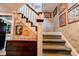 Carpeted stairs with wooden railings, patterned wallpaper and dark wood accents at 611 E Marion St, Shelby, NC 28150