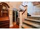 Staircase with carpeted steps, wooden railings and patterned wallpaper at 611 E Marion St, Shelby, NC 28150
