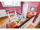 A stairway with white rails, wooden banister and pink walls leads to the second story at 611 E Marion St, Shelby, NC 28150