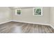 Finished basement space with wood-look floors, natural light, and white trim at 6328 Beecher Dr, Charlotte, NC 28215