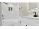 Stylish bathroom with white tile, a modern vanity, sleek fixtures, and a shower-tub combo at 6328 Beecher Dr, Charlotte, NC 28215