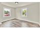 Bright bedroom with two windows offering ample natural light and wood-look floors at 6328 Beecher Dr, Charlotte, NC 28215