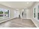 Open-concept living room with neutral walls, wood-look floors, and bright natural light at 6328 Beecher Dr, Charlotte, NC 28215