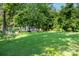Expansive backyard showcasing a well-manicured lawn and a wooded backdrop at 636 N Center St, Statesville, NC 28677