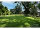 Expansive backyard featuring lush greenery and mature trees, perfect for outdoor activities at 636 N Center St, Statesville, NC 28677