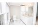 Bright bathroom with white cabinets, marble countertop, and tile flooring at 636 N Center St, Statesville, NC 28677